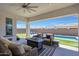 Serene outdoor patio with pool views, plush seating, and lush landscaping at 11807 W Parkway Ln, Avondale, AZ 85323
