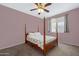 Bedroom with a four poster bed frame, neutral walls and carpeting, and bright window light at 1281 E Frances Ln, Gilbert, AZ 85295