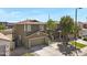 Home's inviting exterior features a spacious driveway and a well-maintained lawn, complemented by desert landscaping at 1281 E Frances Ln, Gilbert, AZ 85295