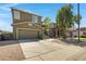 Street view of a two-story home with a two car garage, an elevated front entrance and mature landscaping at 1281 E Frances Ln, Gilbert, AZ 85295