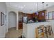 Modern kitchen with dark cabinets, stainless steel appliances, and stylish pendant lighting at 1281 E Frances Ln, Gilbert, AZ 85295