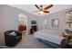 Spacious main bedroom with archway to ensuite bathroom, ceiling fan, and carpeting at 1281 E Frances Ln, Gilbert, AZ 85295
