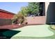 Backyard putting green with lush landscaping, creating a private and recreational space at 13686 N 151St Dr, Surprise, AZ 85379