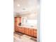 Bathroom with double sinks, wood cabinets, and a large mirror at 13686 N 151St Dr, Surprise, AZ 85379