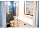 Modern bathroom with a glass-enclosed shower, updated vanity, and mosaic tile accents, offering a clean and stylish space at 13686 N 151St Dr, Surprise, AZ 85379