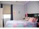 Cozy bedroom with colorful decor, soft lighting, and ample space for relaxation, creating a comfortable retreat at 13686 N 151St Dr, Surprise, AZ 85379