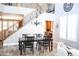 Elegant dining room with a staircase, chandelier, and ample natural light at 13686 N 151St Dr, Surprise, AZ 85379