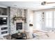 Comfortable living room featuring a stone fireplace and neutral color palette at 13686 N 151St Dr, Surprise, AZ 85379