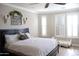 Cozy bedroom with a black headboard bed, crown molding, and white window shutters at 13686 N 151St Dr, Surprise, AZ 85379