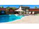 Inviting pool area with a shed, lounge chairs, a basketball hoop, and lush landscaping at 13686 N 151St Dr, Surprise, AZ 85379