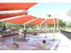 The community splash pad features colorful water features and shaded areas, providing a fun and safe recreational space at 13686 N 151St Dr, Surprise, AZ 85379
