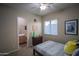 Bedroom featuring a twin bed with a decorative Pikachu pillow, ceiling fan, and en suite bathroom at 14045 E Geronimo Rd, Scottsdale, AZ 85259