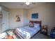 Bedroom featuring a full bed with a decorative Chewbacca pillow, ceiling fan, and Star Wars artwork at 14045 E Geronimo Rd, Scottsdale, AZ 85259