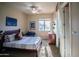 Bedroom featuring a full bed with a decorative Chewbacca pillow, ceiling fan, and desk at 14045 E Geronimo Rd, Scottsdale, AZ 85259