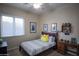 Bedroom featuring a twin bed with a decorative Pikachu pillow, ceiling fan, and playful decor at 14045 E Geronimo Rd, Scottsdale, AZ 85259