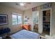 Cozy bedroom features neutral tones, natural light, ceiling fan, and attached bathroom and closet at 14045 E Geronimo Rd, Scottsdale, AZ 85259