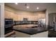 Spacious kitchen featuring natural wood cabinets, stainless steel appliances, and a large island with a black granite countertop at 14045 E Geronimo Rd, Scottsdale, AZ 85259