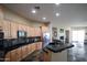 Modern kitchen featuring sleek countertops, light wood cabinets, and a range of high-end appliances at 14045 E Geronimo Rd, Scottsdale, AZ 85259
