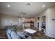 Open-concept living area with a modern kitchen, large dining table, comfortable seating, and plenty of natural light at 14045 E Geronimo Rd, Scottsdale, AZ 85259
