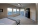 Bright main bedroom with plush carpet, neutral walls, a ceiling fan, and sliding glass door leading to the backyard at 14045 E Geronimo Rd, Scottsdale, AZ 85259
