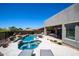 Backyard oasis with a pool, spa, fountain and covered outdoor kitchen and dining area at 14045 E Geronimo Rd, Scottsdale, AZ 85259