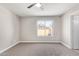 Spacious bedroom boasts a large window, neutral carpeting, and ample natural light at 1408 E Carson Rd, Phoenix, AZ 85042