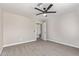 Spacious bedroom includes a ceiling fan, neutral carpeting, and an open doorway at 1408 E Carson Rd, Phoenix, AZ 85042