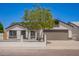 Charming single-Gathering home featuring well-maintained landscaping, a spacious driveway, and a welcoming two-car garage at 1408 E Carson Rd, Phoenix, AZ 85042