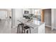 Modern kitchen featuring granite counters, stainless appliances, an island with seating, and white cabinetry at 1408 E Carson Rd, Phoenix, AZ 85042