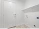 Laundry room with a white door, shelving, and washer/dryer hookups at 1408 E Carson Rd, Phoenix, AZ 85042