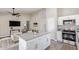 Open concept living room and kitchen area with modern appliances and a ceiling fan at 1408 E Carson Rd, Phoenix, AZ 85042