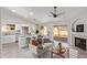 Open-concept living area with a kitchen island, white cabinets, modern decor, and sliding glass doors to the backyard at 1408 E Carson Rd, Phoenix, AZ 85042