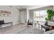 Bright living room with modern decor, wood-look tile flooring, a large window, and neutral paint, creating an inviting space at 1408 E Carson Rd, Phoenix, AZ 85042