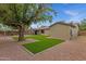Beautiful backyard featuring artificial turf, mature tree, and large brick-paved patio at 14215 N 36Th Way, Phoenix, AZ 85032