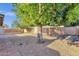 Spacious backyard with gravel and brick landscaping under the shade of mature trees at 14215 N 36Th Way, Phoenix, AZ 85032