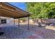 Large backyard featuring a brick patio, gravel landscaping, mature trees and a covered patio at 14215 N 36Th Way, Phoenix, AZ 85032