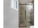 Modern bathroom showcasing tiled glass shower with black hardware and a window at 14215 N 36Th Way, Phoenix, AZ 85032