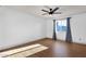Bedroom featuring hardwood floors, a window with curtains, and neutral decor at 14215 N 36Th Way, Phoenix, AZ 85032