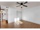 Bedroom with wood-look flooring, ceiling fan, and closet at 14215 N 36Th Way, Phoenix, AZ 85032