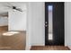Bright entryway with a modern door, flowing into a spacious room with sleek, light-colored laminate flooring at 14215 N 36Th Way, Phoenix, AZ 85032