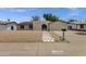 Inviting home exterior with solar panels, gravel yard, and unique arched entryway at 14215 N 36Th Way, Phoenix, AZ 85032