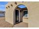Charming arched entrance with a dark front door and adjacent window, creating a welcoming first impression at 14215 N 36Th Way, Phoenix, AZ 85032