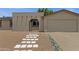 Close-up of the charming front entrance with a stucco archway and desert landscaping at 14215 N 36Th Way, Phoenix, AZ 85032