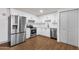 Modern kitchen with stainless steel appliances, white cabinets, and wood-look flooring at 14215 N 36Th Way, Phoenix, AZ 85032