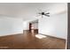 Spacious room with sleek, light-colored laminate flooring, bright lighting, and open access to the backyard at 14215 N 36Th Way, Phoenix, AZ 85032