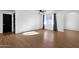 Bright living room featuring wood floors, a ceiling fan, and an arched doorway at 14215 N 36Th Way, Phoenix, AZ 85032