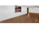 Bright room with laminate flooring, a large window, and access to the backyard at 14215 N 36Th Way, Phoenix, AZ 85032