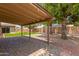 Covered patio showcasing a brick paver floor, string lights, and views of the backyard at 14215 N 36Th Way, Phoenix, AZ 85032