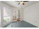 Bright bedroom with tile flooring, ceiling fan, and French doors leading to another room at 1425 E Commerce Ave, Gilbert, AZ 85234
