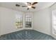 Bright bedroom featuring tile flooring, ceiling fan, and large windows with natural light at 1425 E Commerce Ave, Gilbert, AZ 85234